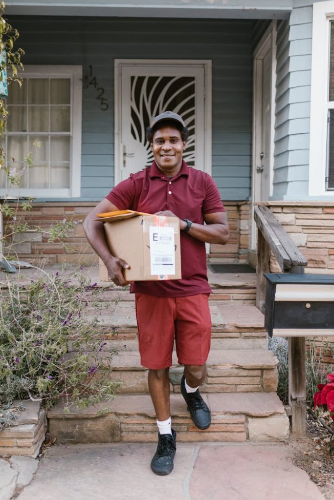 Courier delivering a package on a porch, symbolizing efficient home delivery service.